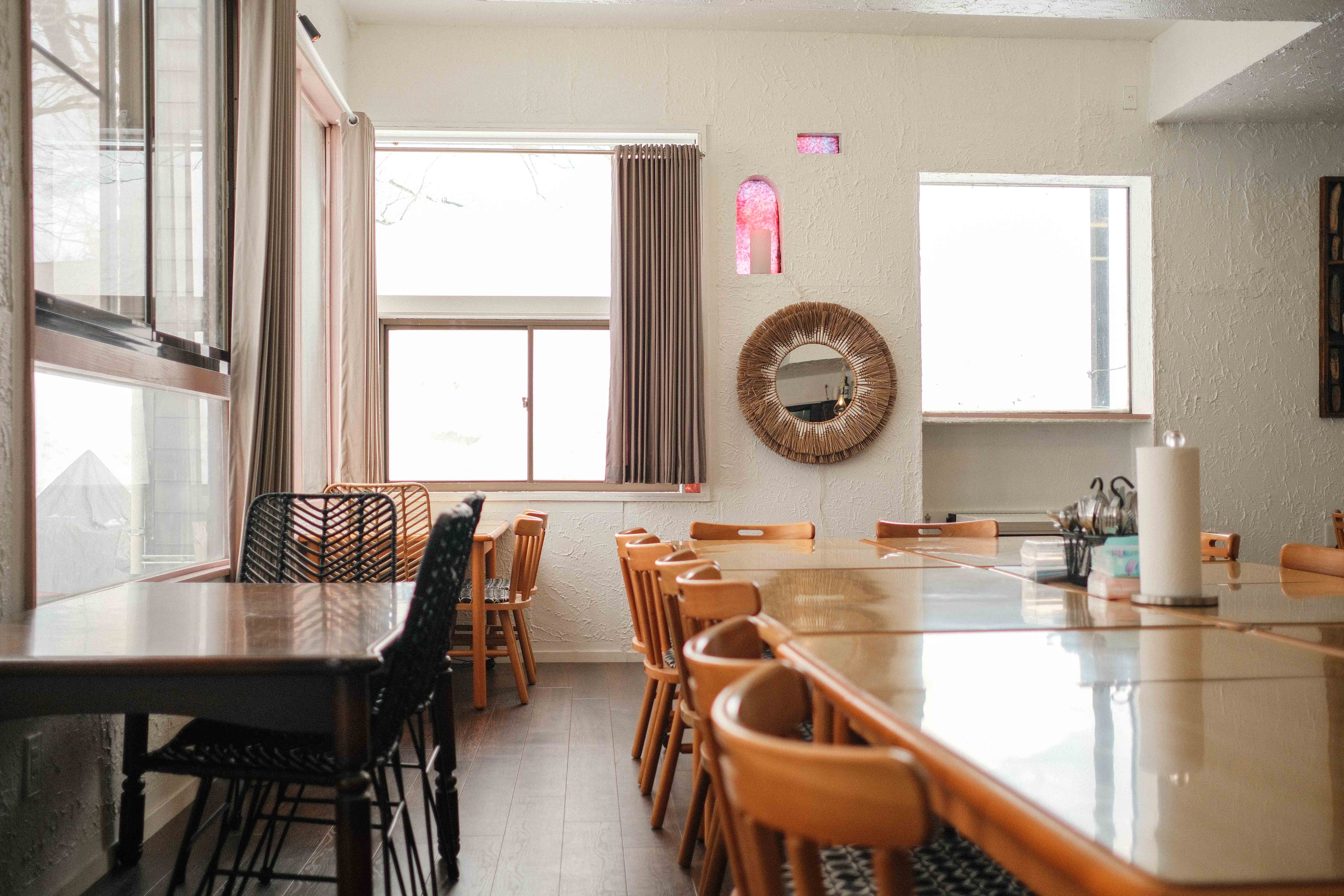Dining room with communal tables and stained glass
